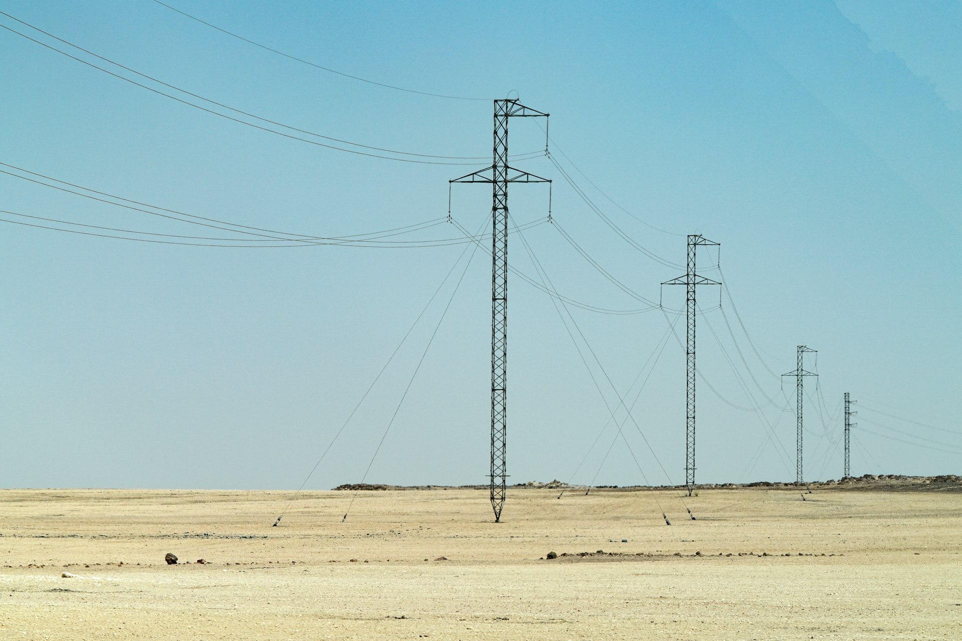 Power lines stretch across a vast, open landscape.